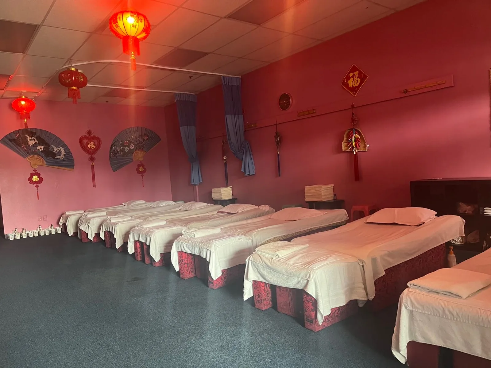 The treatment room, with paper lanterns and a row of low massage tables